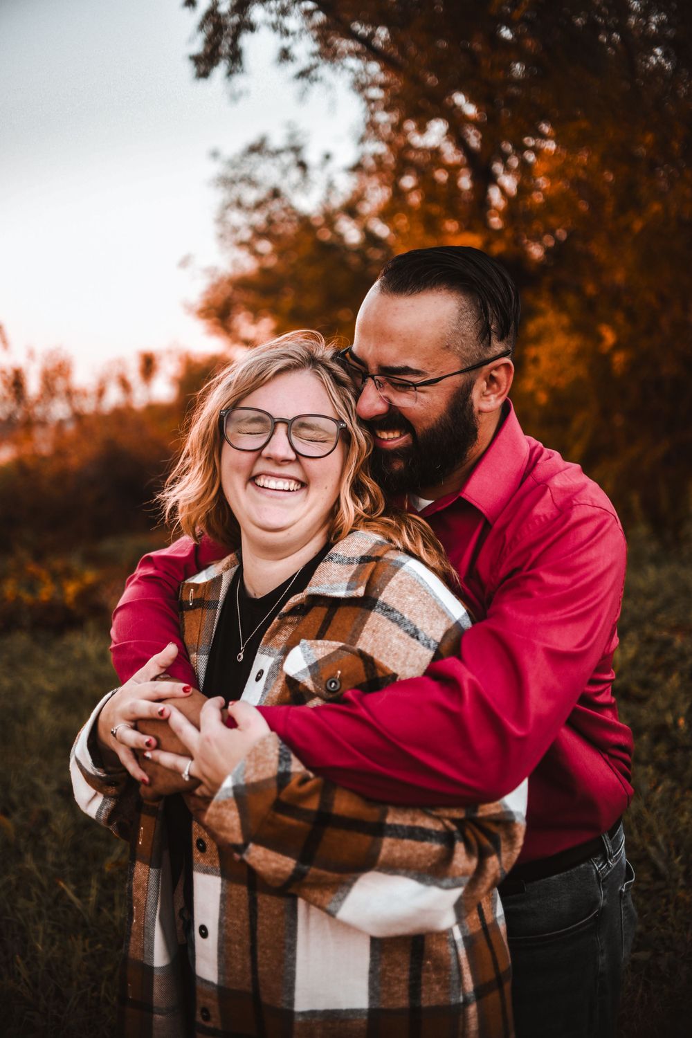 A joyful embrace captured during golden hour in autumn.