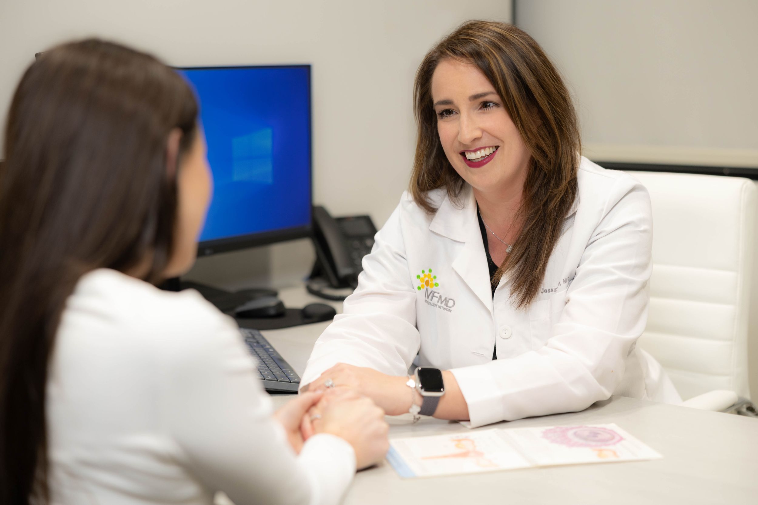 Healthcare professionals engage in collaborative discussion at a meeting in a modern medical office.