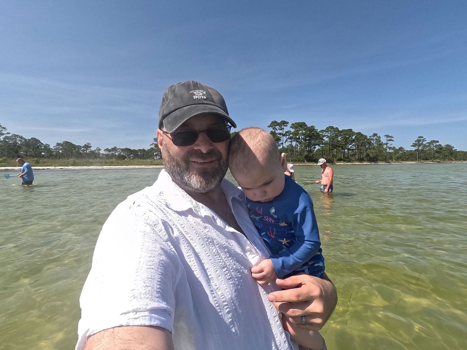 Father holding his young child outdoors during a family adventure.