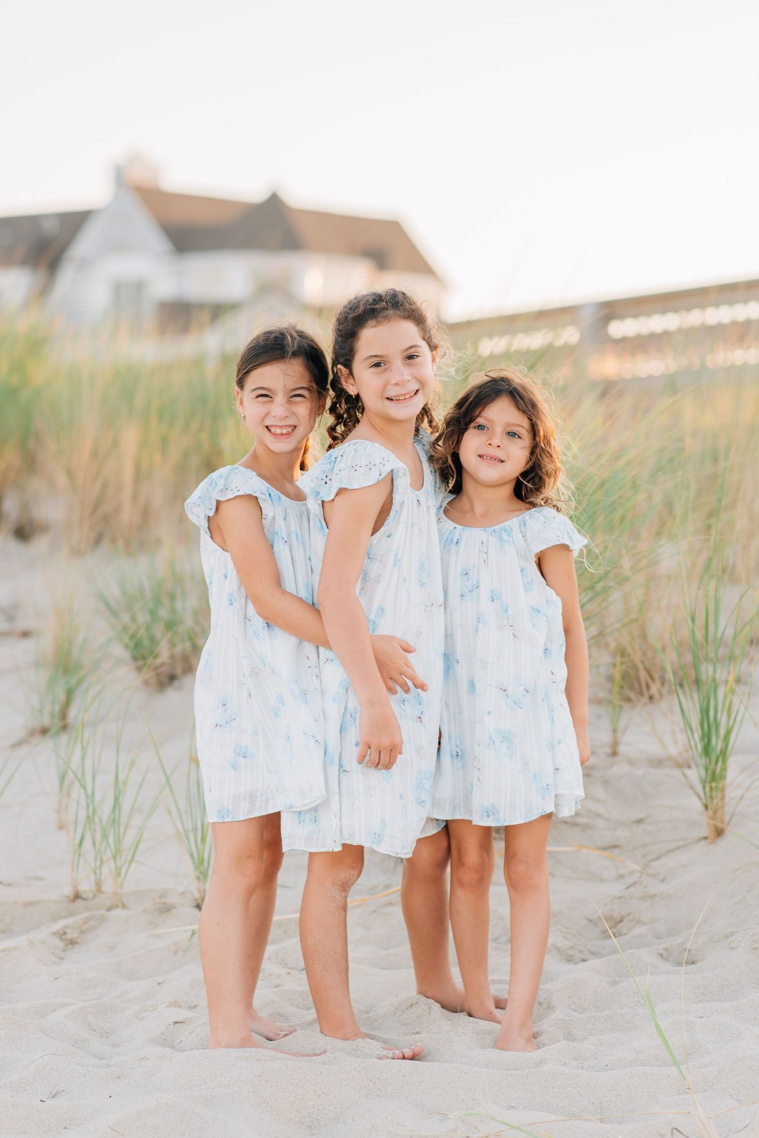 Girls playing in the sand during a Jersey Shore family beach photo session in Monmouth Beach New Jersey.