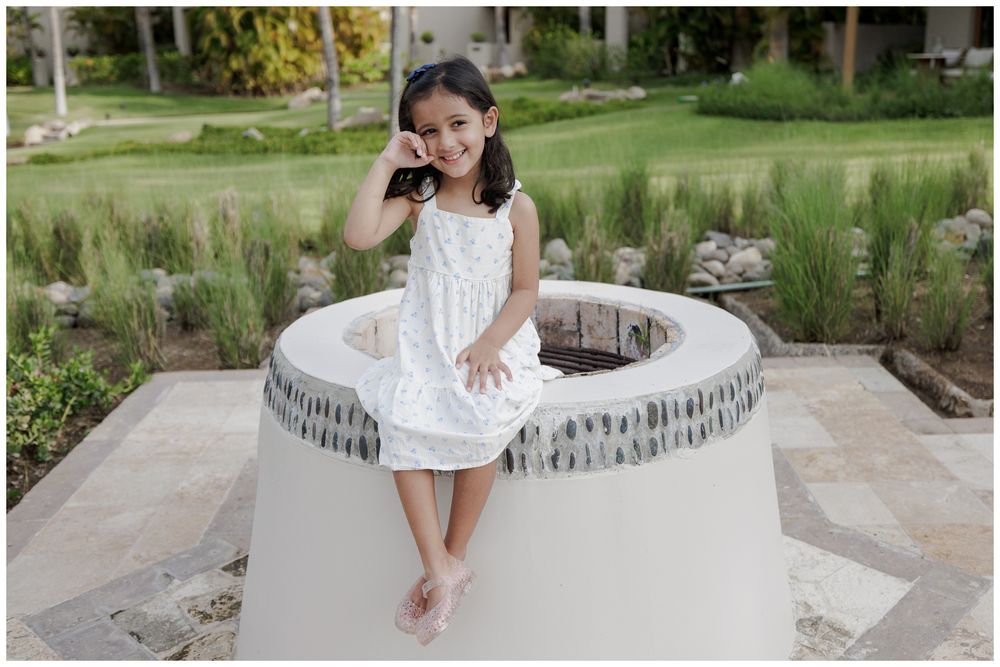 St Regis Punta Mita Family Photographer capturing a barefoot portrait of a young girl in a lush outdoor setting during Sayulita Family Photo