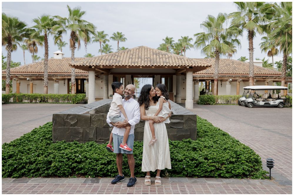 St Regis Punta Mita Family Photographer welcoming your Beach Family Photo Session at a luxury resort entrance surrounded by tropical palms.