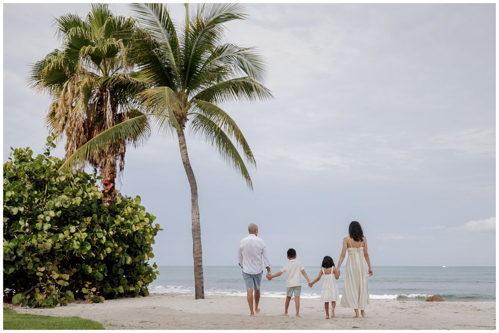St Regis Punta Mita Family Photographer capturing a beach walk toward the ocean with palms during Puerto Vallarta Family Photographer.