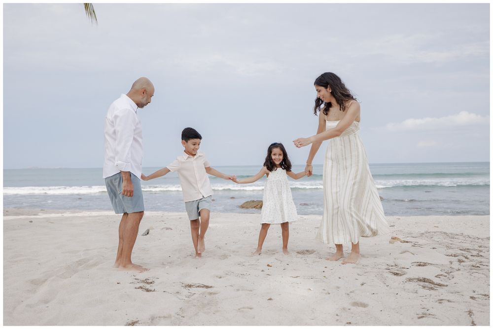 St Regis Punta Mita Family Photographer capturing a joyful beach moment with ocean waves during Beach Family Photo Session.