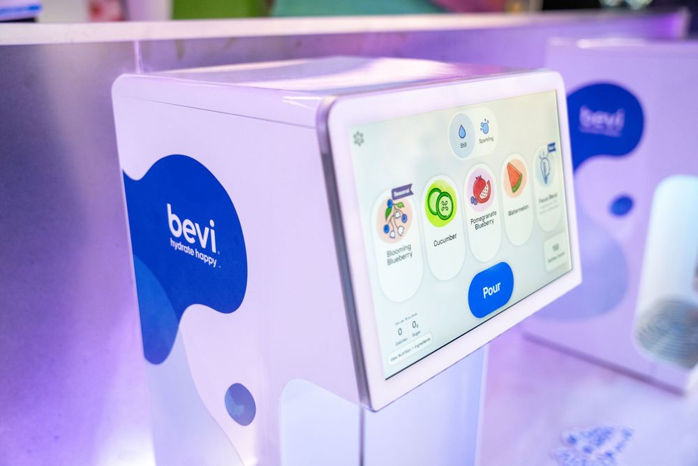 Bevi smart water dispenser touchscreen interface showing flavored water options at an event.
