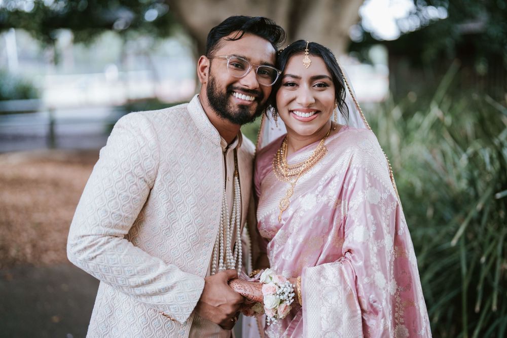 Bride and groom laughing together during couple portraits in a Sydney park