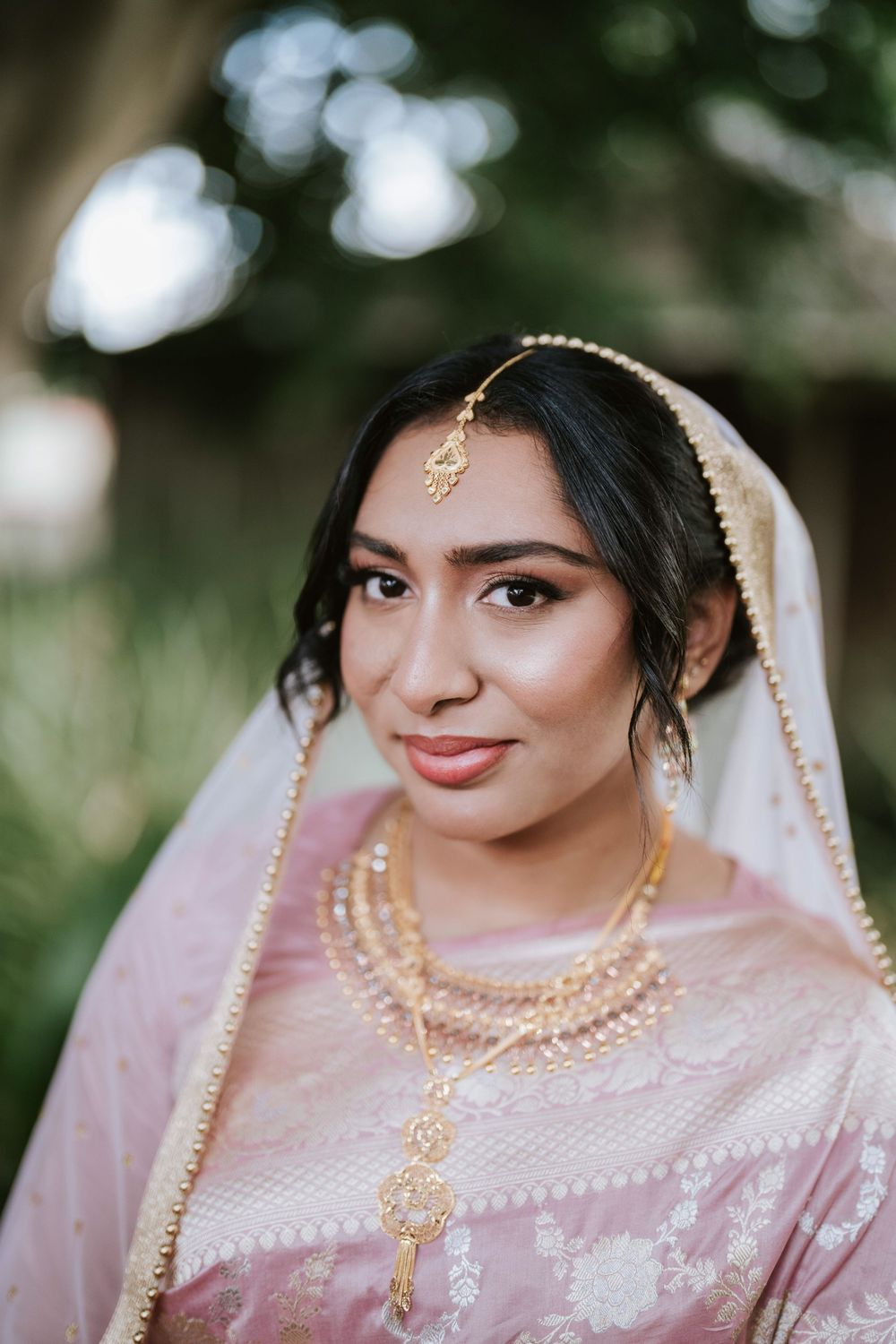 Close-up bridal portrait with gold jewellery and soft natural light in Sydney