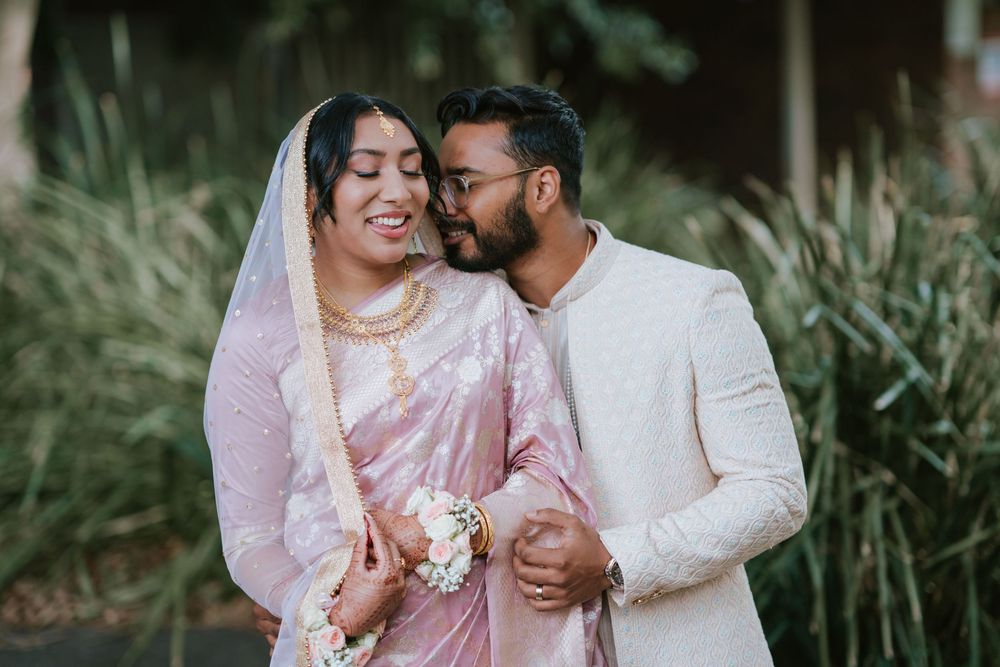 Groom kissing the bride on the forehead during golden hour couple portraits