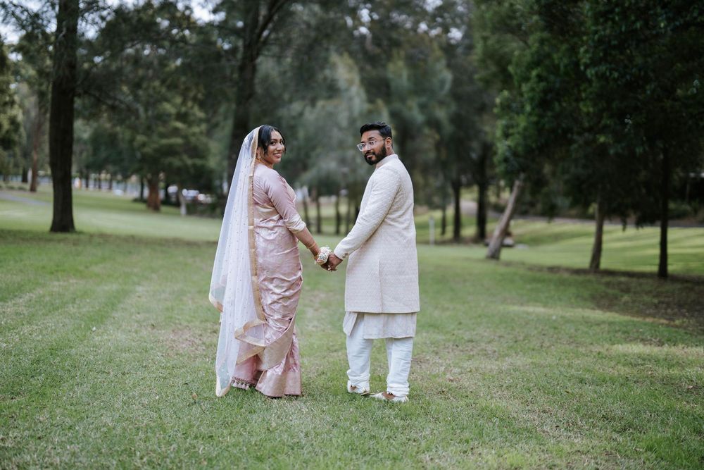 Bride and groom walking hand in hand across the lawn in Sydney - Nikah couple portraits