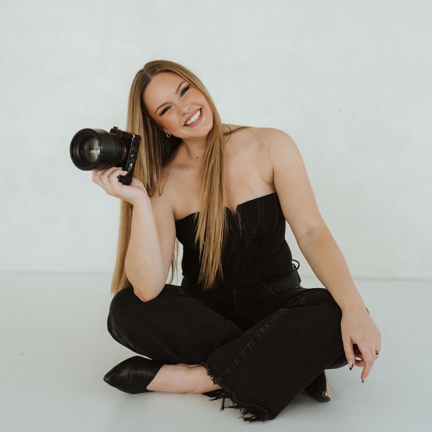 Arizona Wedding Photographer smiles on a neutral backdrop