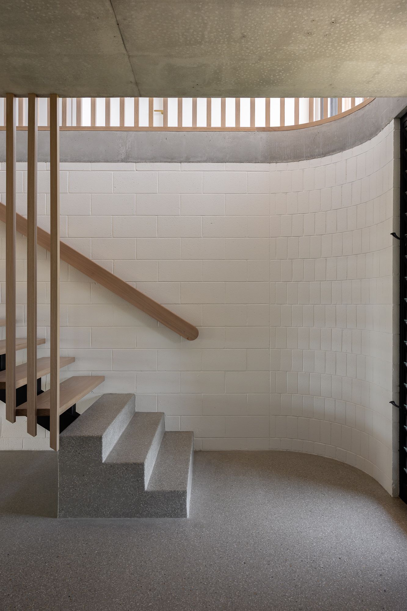 Interior entry with curved white staircase. Interior photography in Shoalhaven NSW.