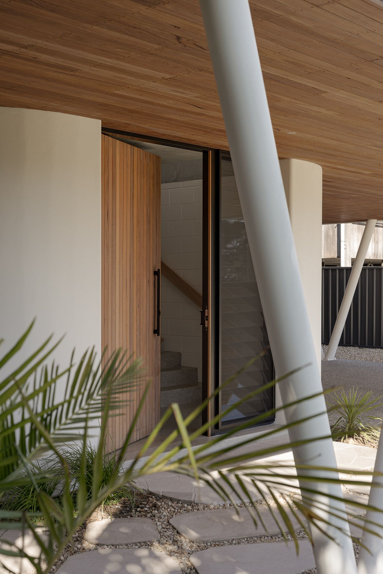 Detail of an angled white column under a timber soffit surrounded by coastal planting, Shoalhaven architectural photography.