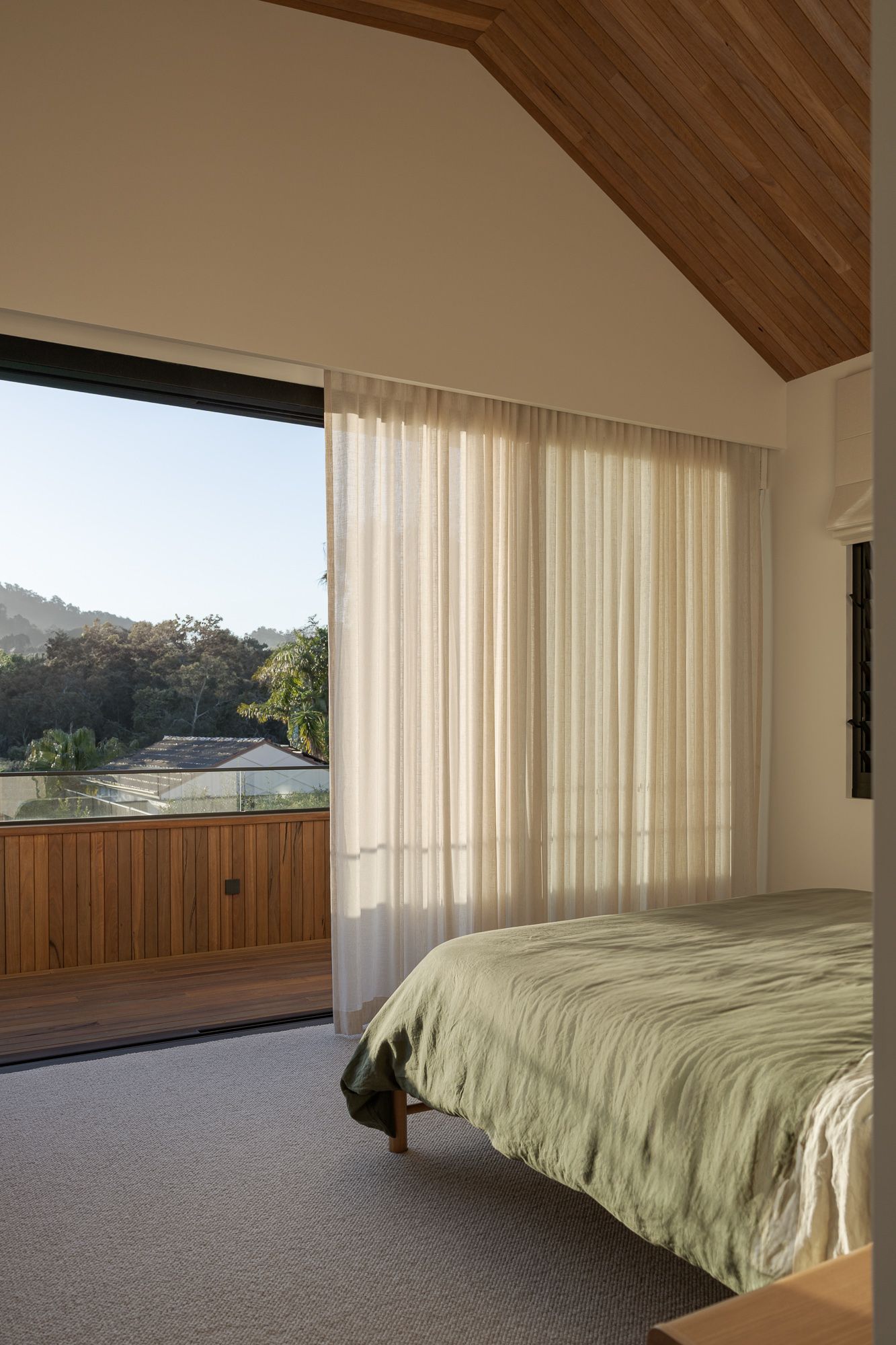 Bedroom with a timber ceiling, architecturally designed.