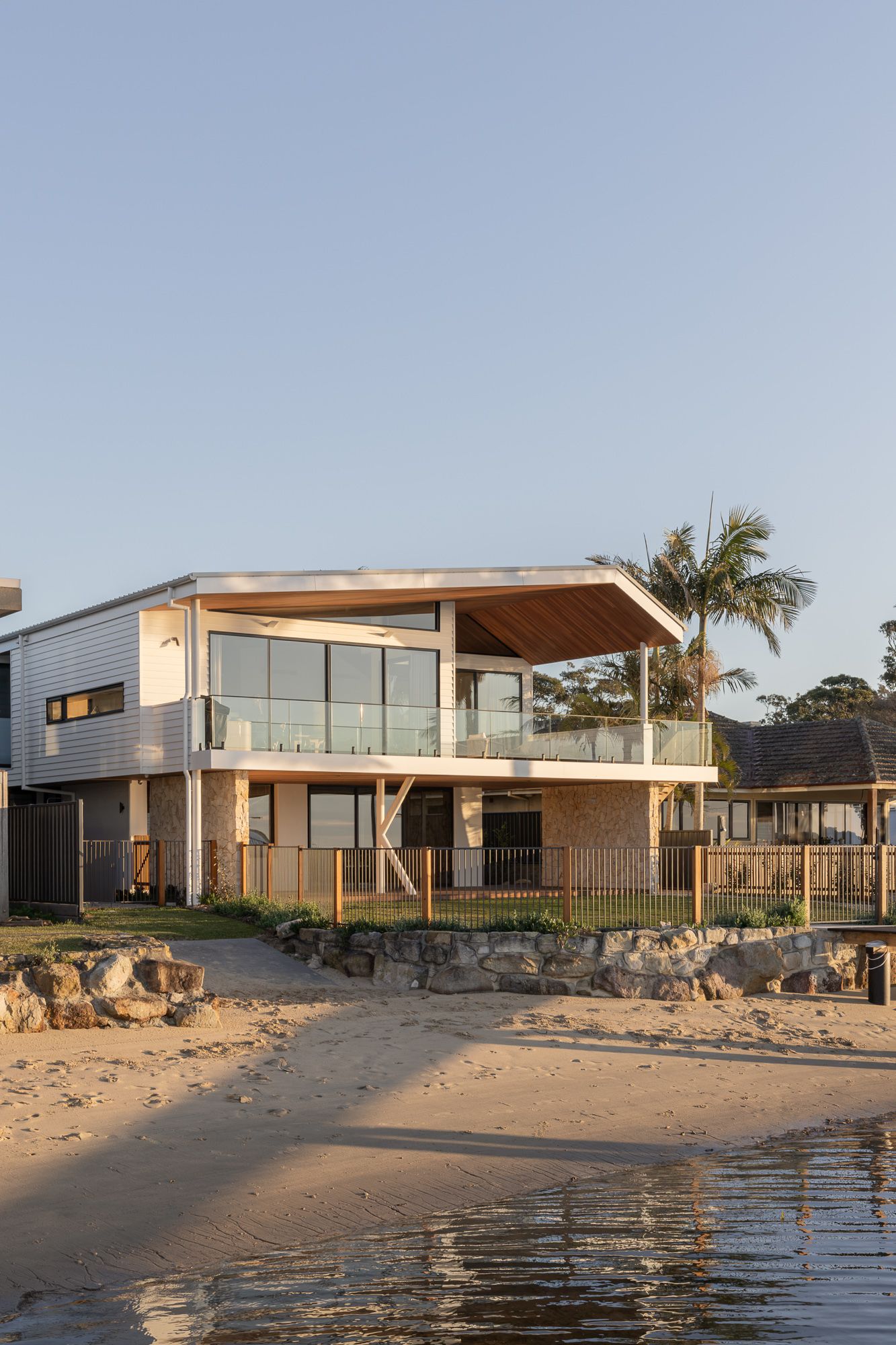 Architectural photography of a  riverside home on the NSW South Coast, photographed from the water's edge right on sunrise.
