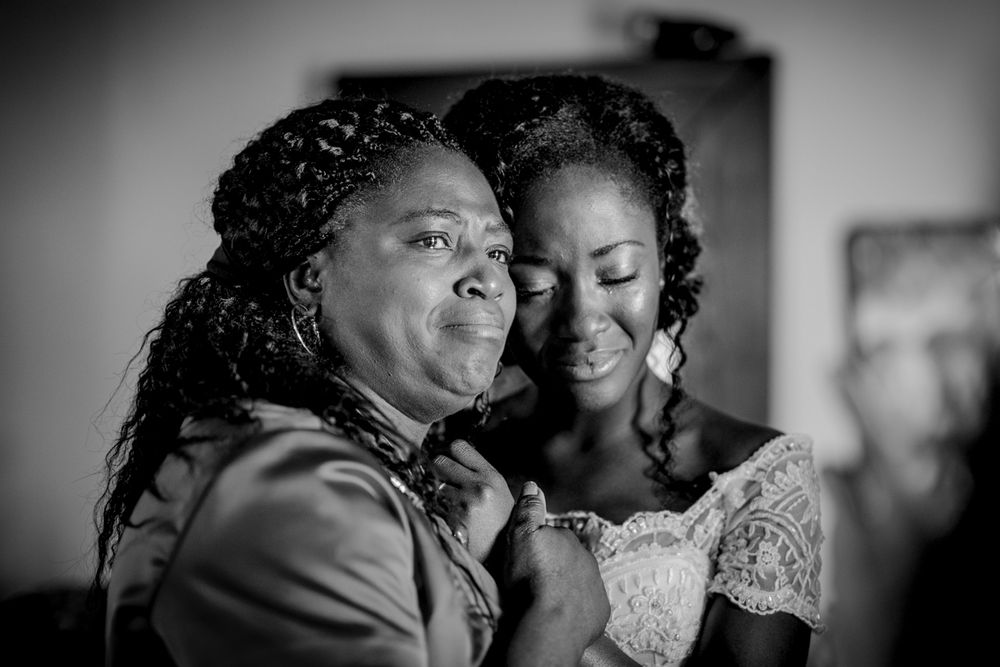 Emotional black and white photo of a bride sharing a tender moment with her mother.