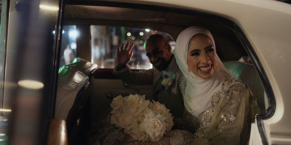 Bride and Groom in the classic car at the end of the wedding