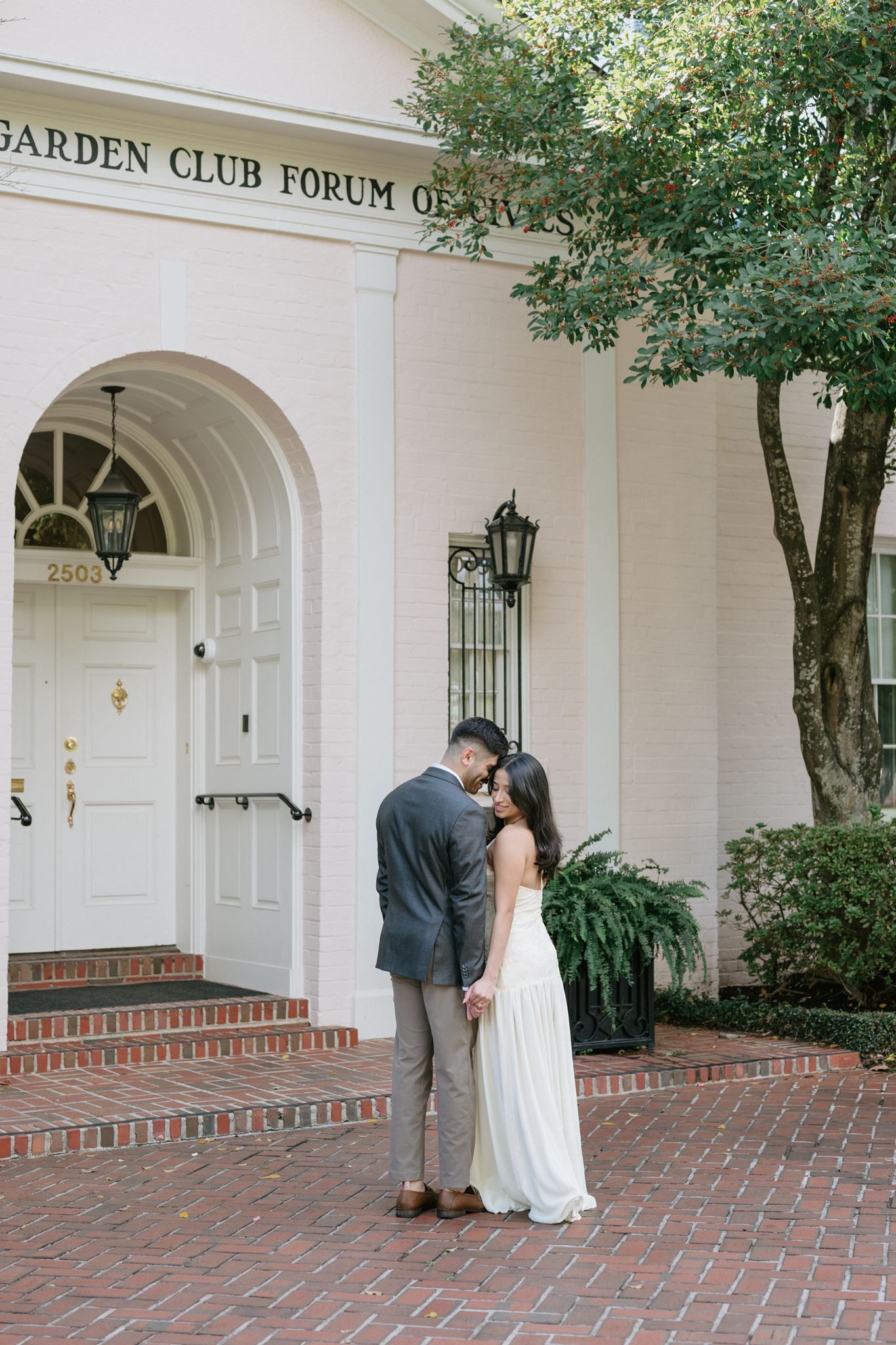 Bride and groom sharing an intimate moment in front of River Oaks Garden Club Forum in Houston, Tx.