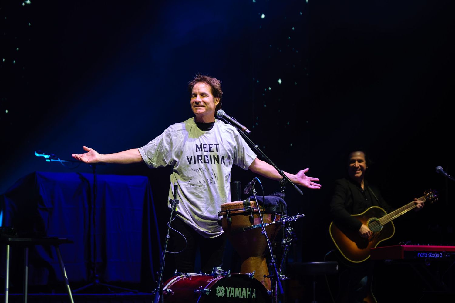 Pat Monahan of Train wears a white t-shirt that reads Meet Virgina during a concert in Gainesville, Fl.