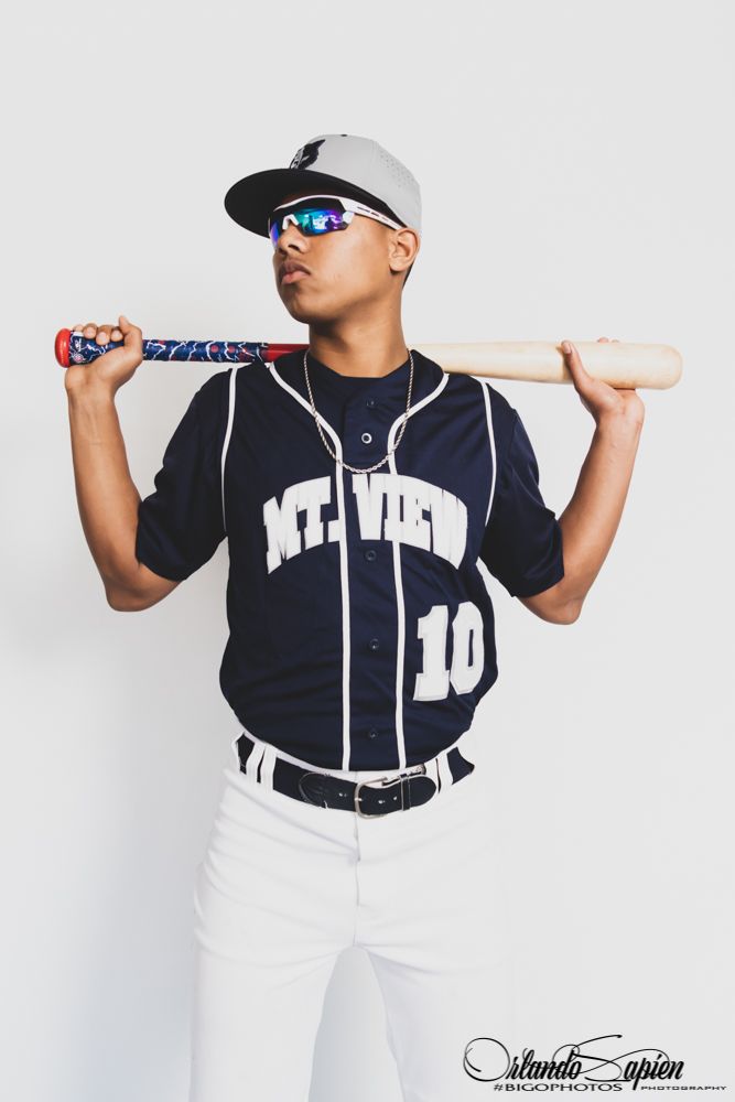Baseball player in Mt. View #10 jersey holding bat across shoulders, wearing sunglasses and cap.
