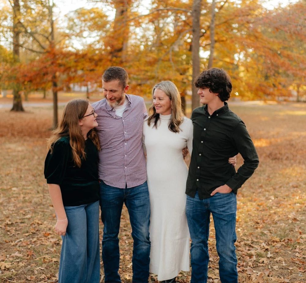 A warm golden hour fall family portrait session captured among the autumn leaves at Berry College in Rome, Georgia by Ella Monroe Photograph