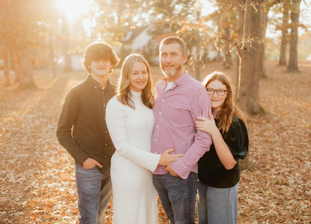 A warm golden hour fall family portrait session captured among the autumn leaves at Berry College in Rome, Georgia by Ella Monroe Photograph