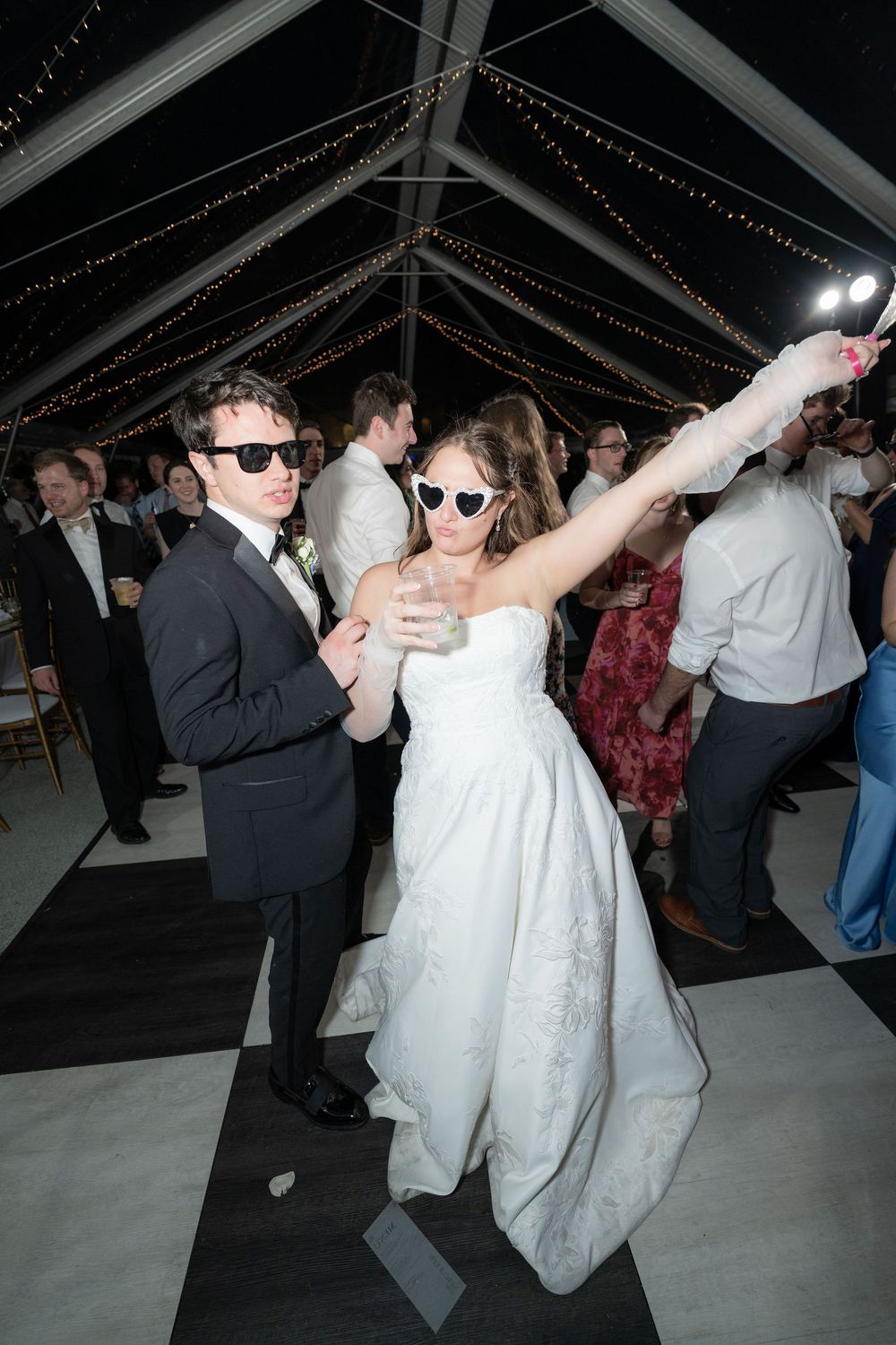Bride dancing in heart shaped sunglasses at The Mansion at Tuckahoe in Jensen Beach, FL