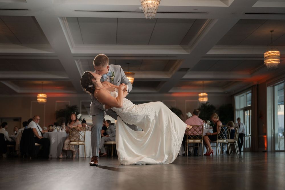 Groom dipping bride for a kiss on the dance floor at Pelican Club in Jupiter, FL