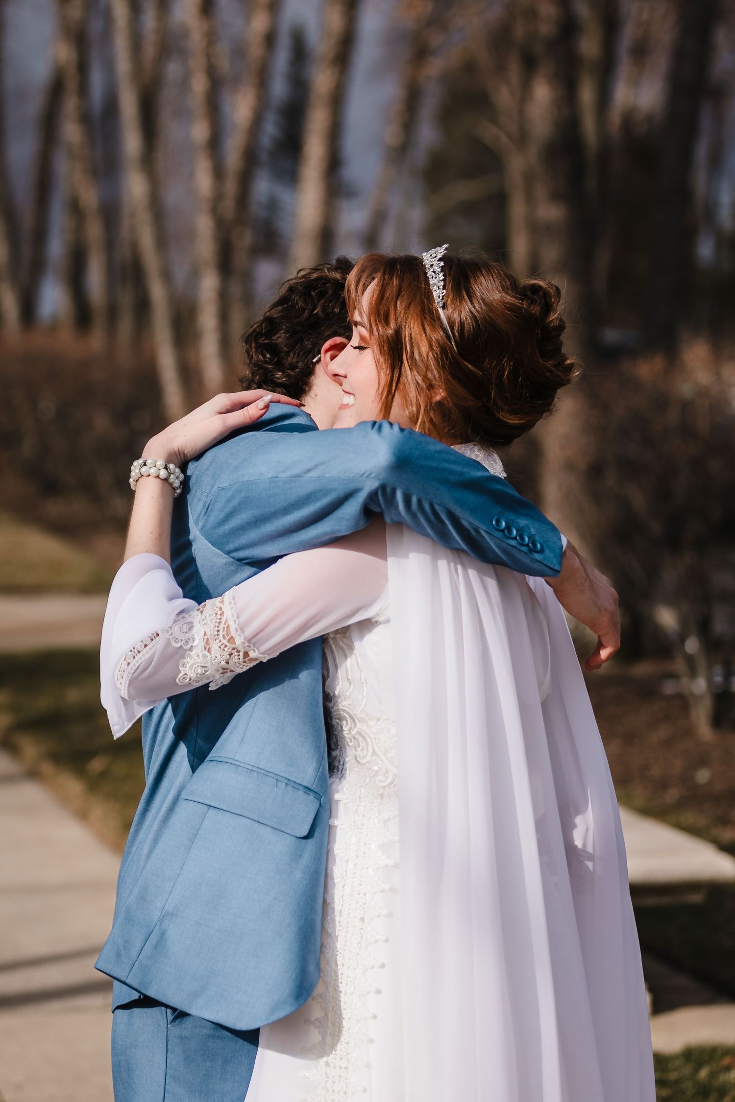 The bride and groom embrace as they complete their first look on their wedding day.