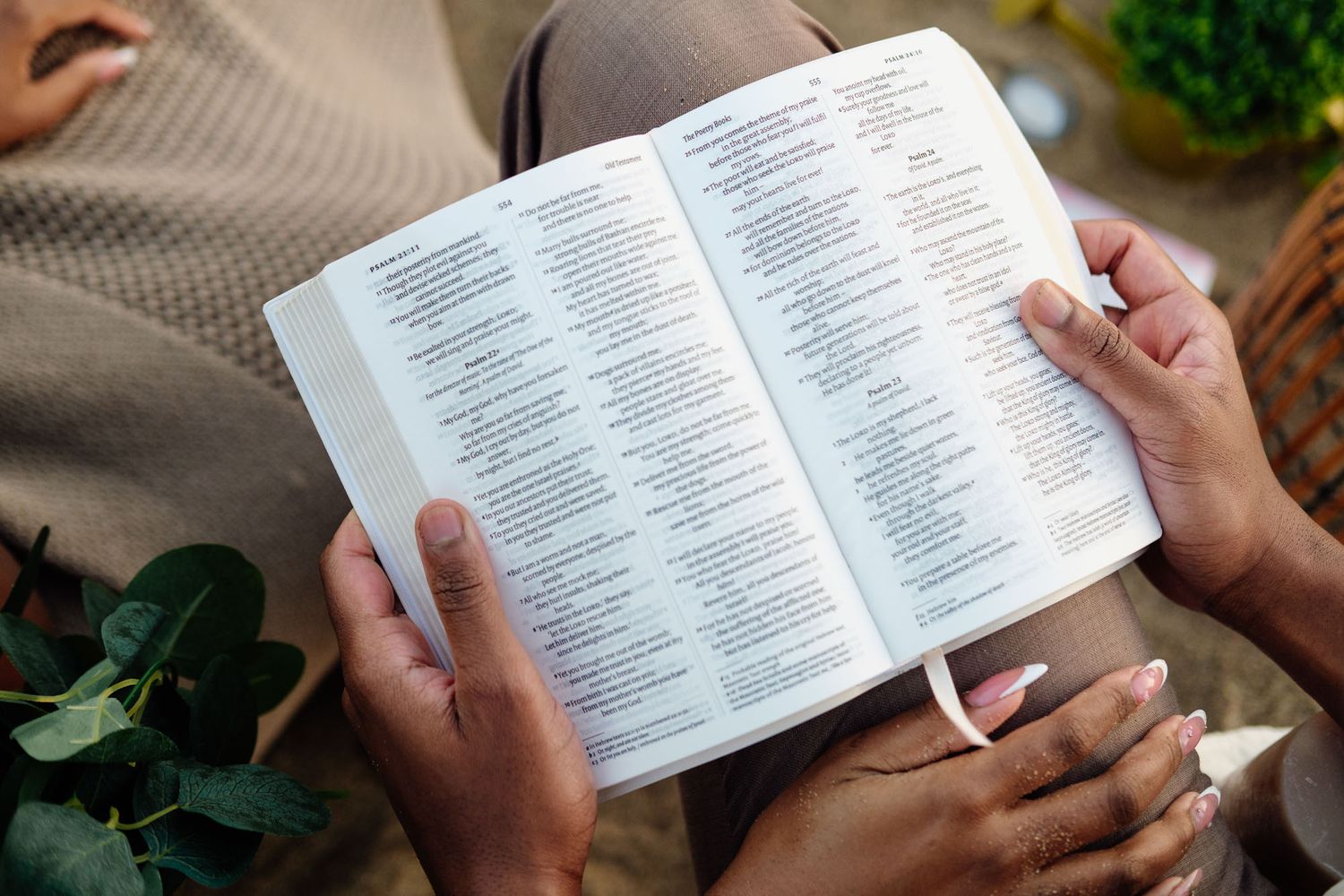 Expecting parents holding a Bible during their meaningful maternity session