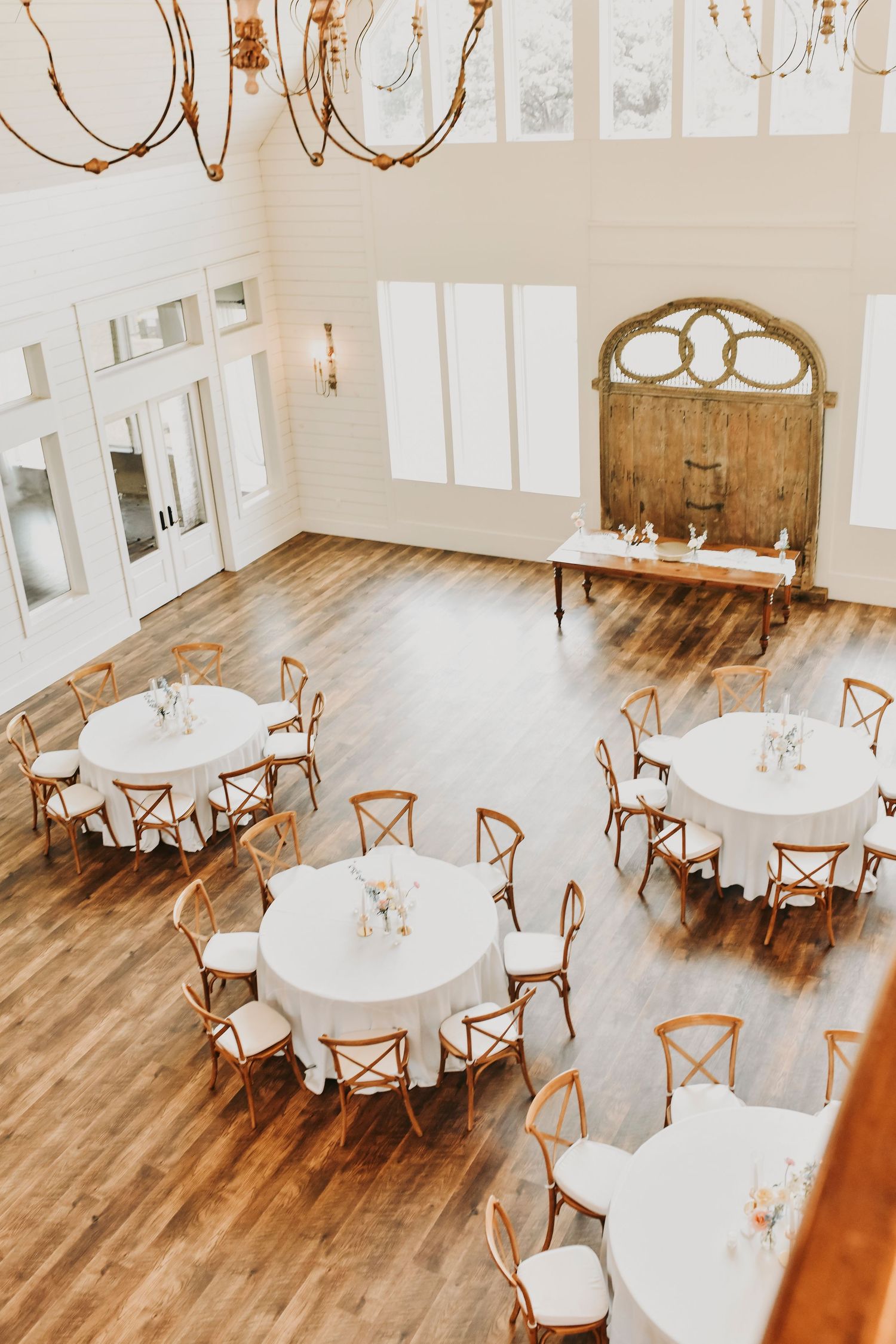 French Farmhouse wedding reception decorated with romantic candles and pastel florals