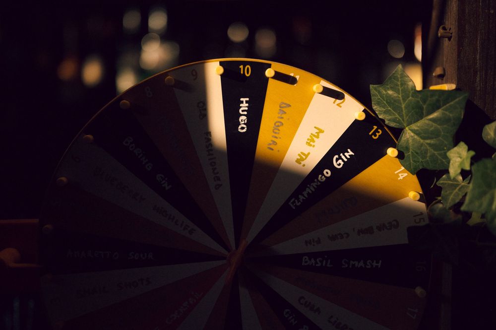 A fan-shaped color swatch display with gold and black tones arranged in a semicircle, set against a dark background.