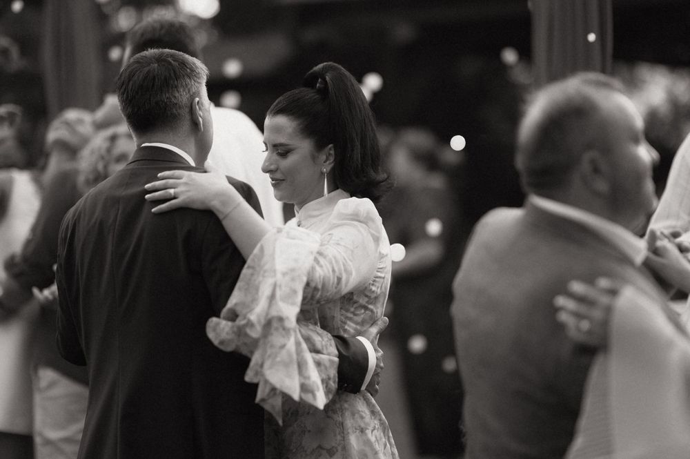 Black and white photo of couples dancing elegantly at a formal event or wedding reception.