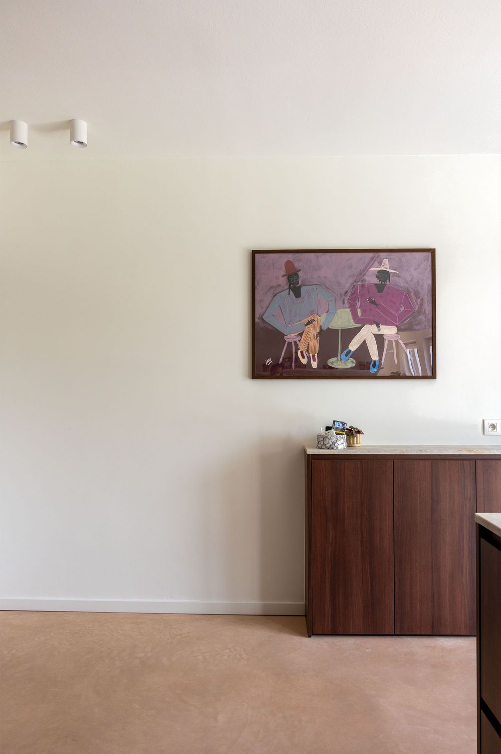 Modern living room with walnut cabinet, cork floor, and figurative painting of two seated figures in purple tones.