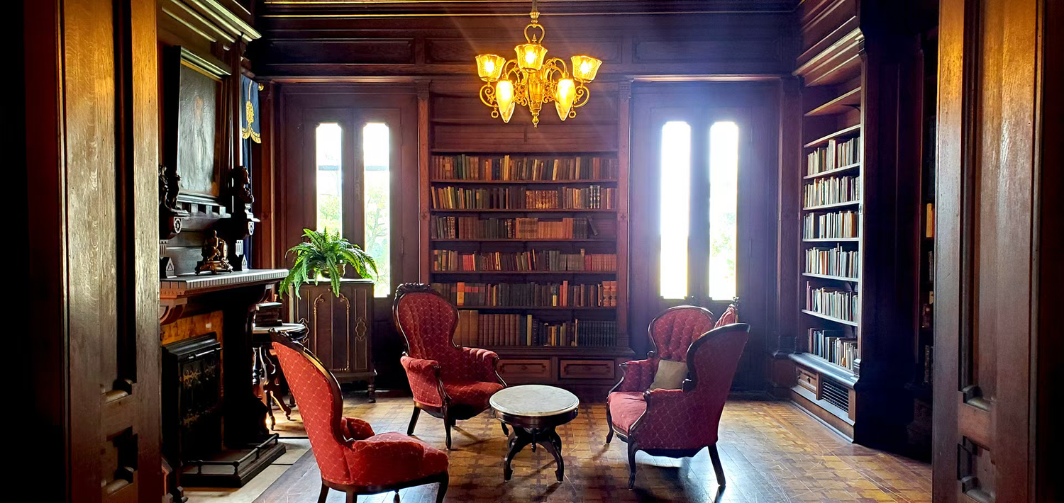 Elegant wood-paneled library with red velvet chairs at the mac-o-chee wedding venue castle
