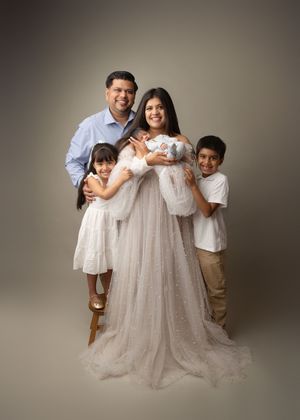 Family portrait with parents, children, and newborn baby during a studio newborn photography session in New Jersey.