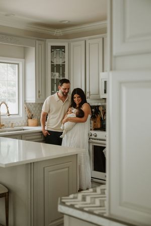 Parents with their newborn baby during a relaxed in-home lifestyle newborn photography session in New Jersey.
