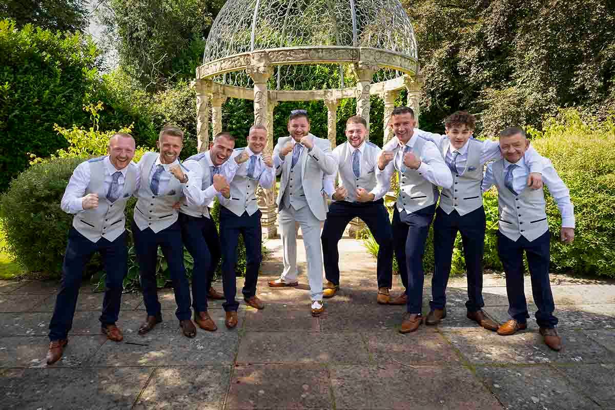 Groom and groomsmen posing in front of the gazebo at Dalston Hall- Carlisle
