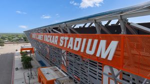 Exterior view of UTRGV Robert L. Vackar Stadium with bold orange signage and metal facade.