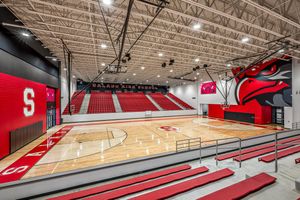 Salado High School gymnasium with red bleachers, hardwood court, and eagle mascot mural.