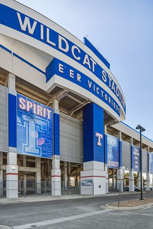 Exterior facade of Wildcat Stadium featuring blue and white colors with Spirit and Loyalty banners.