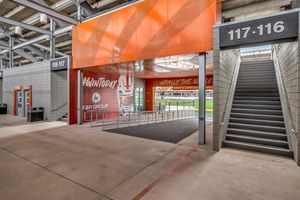Stadium entrance gate 116-117 with orange canopy and stairway leading to UTRGV football field.