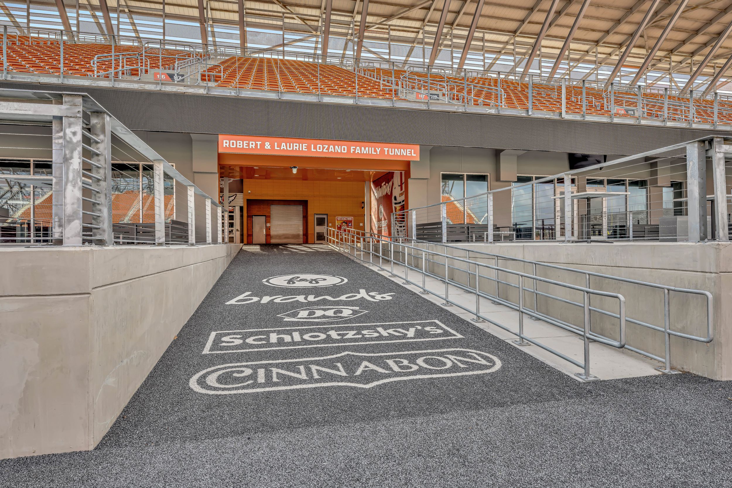 Stadium entrance walkway with Schlotzsky's and Cinnabon branded floor graphics.
