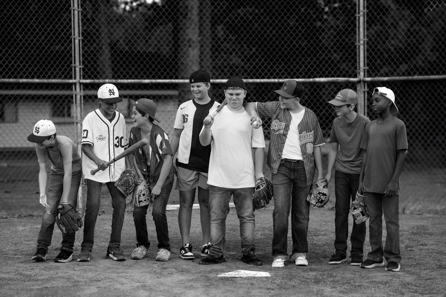 teen boys playing baseball on a dirt field in White County, Arkansas