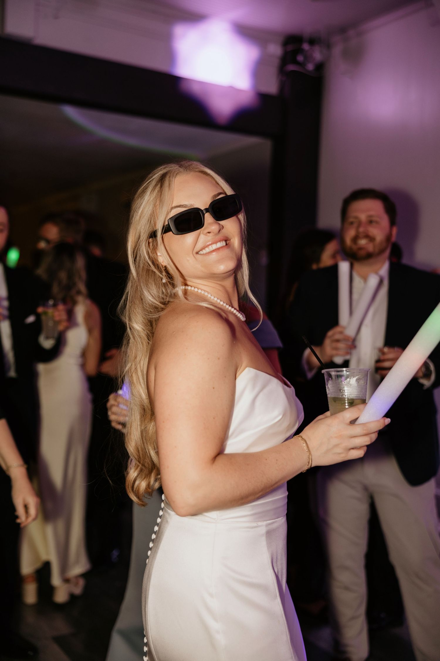 Bride dancing with sunglasses during the reception at a Georgia wedding venue.