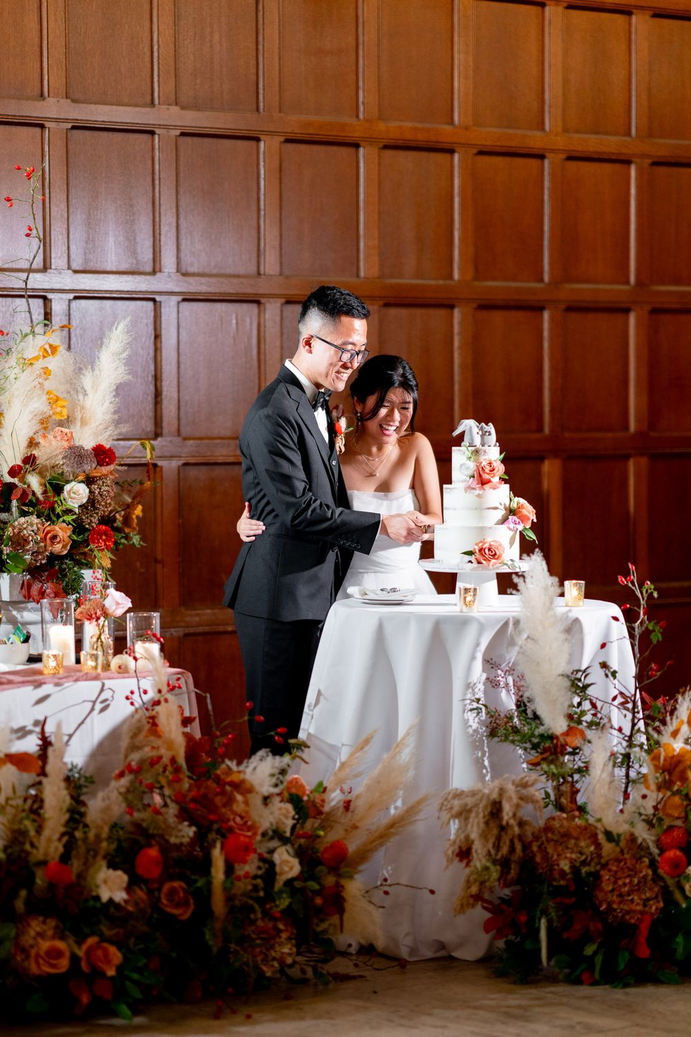 Couple cutting cake at Great Hall, Hart House
