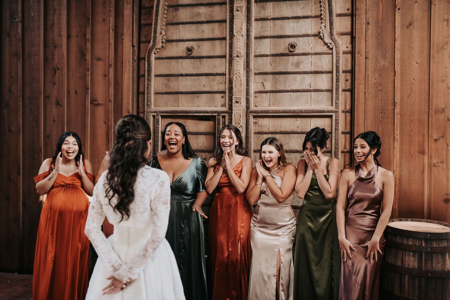 Bridesmaids helping bride into vintage lace wedding gown
