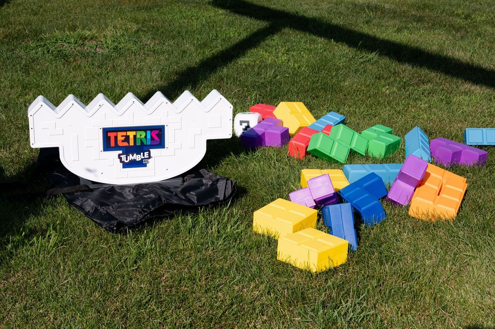 Outdoor Tetris lawn game set with colorful foam pieces and white game board on green grass at barn swallow fields in guelph, ontario.