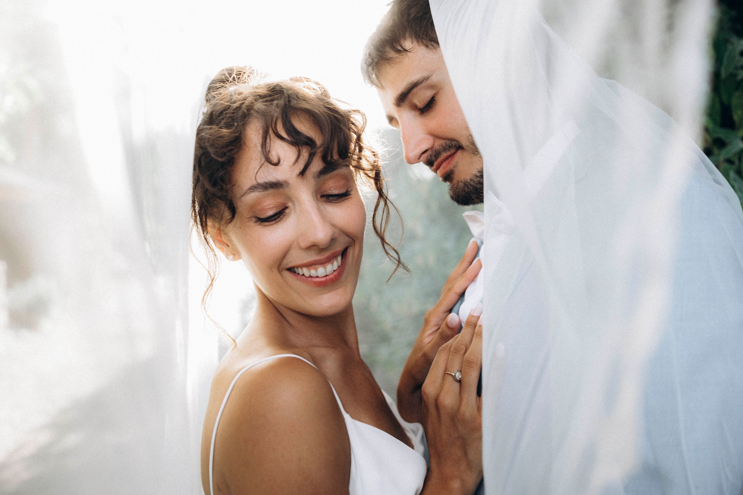 A romantic dance silhouette under stone archways with warm lighting.