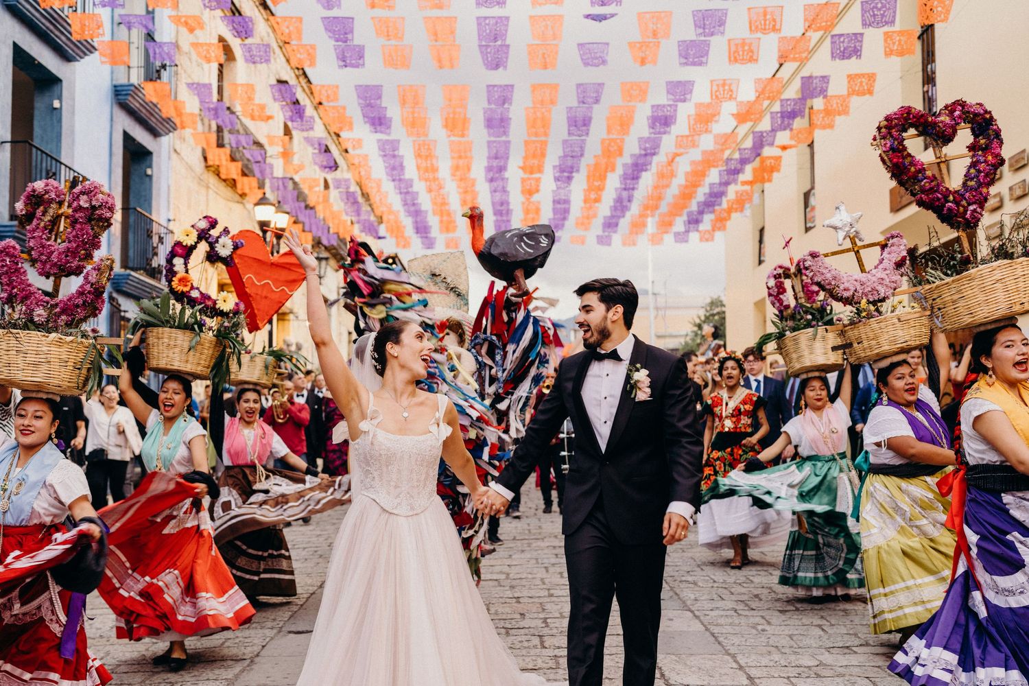 Celebratory wedding moment at sunset with floral arch decorations.