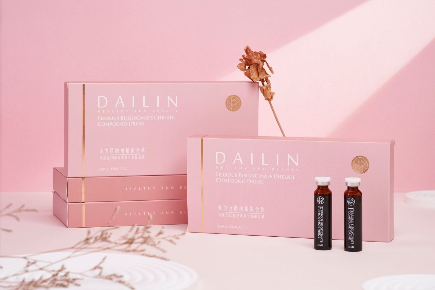 Dailin collagen beauty drink boxes and vials displayed on a pink background with dried flowers.